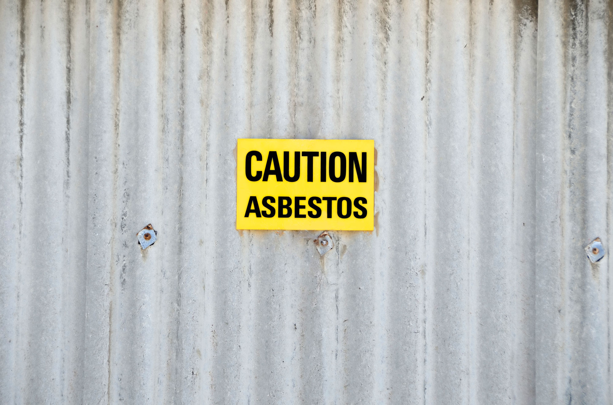 Asbestos Inspection in Newcastle with Warning Sign about danger