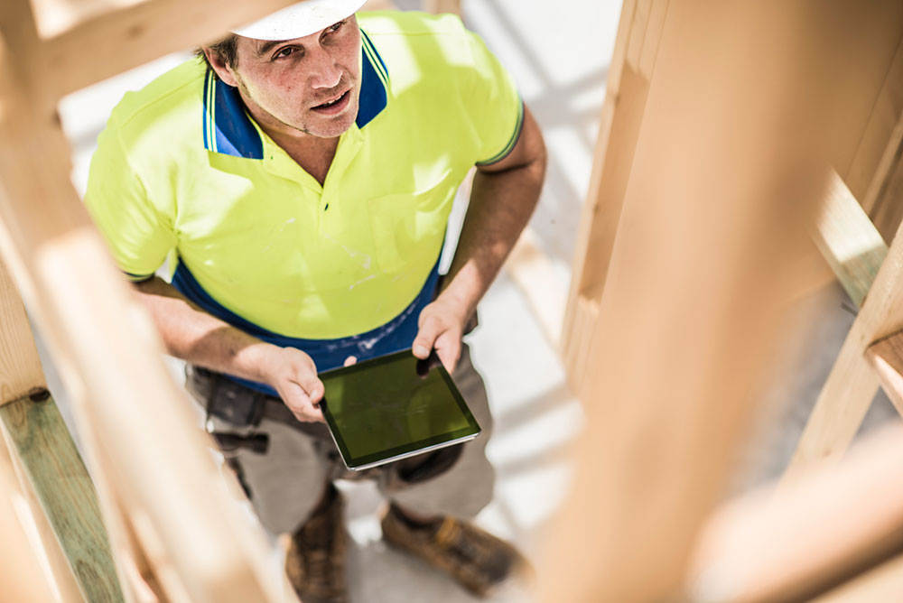 Man with iPad completing Building and Pest Inspection in Newcastle